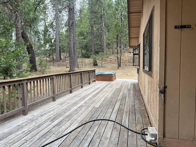 wooden terrace featuring a hot tub