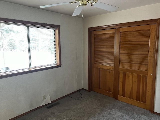 unfurnished bedroom with carpet flooring, ceiling fan, and a closet