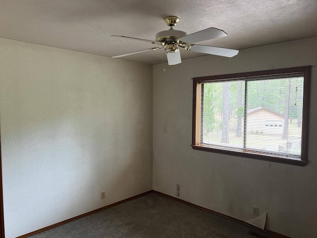 empty room featuring a textured ceiling and ceiling fan