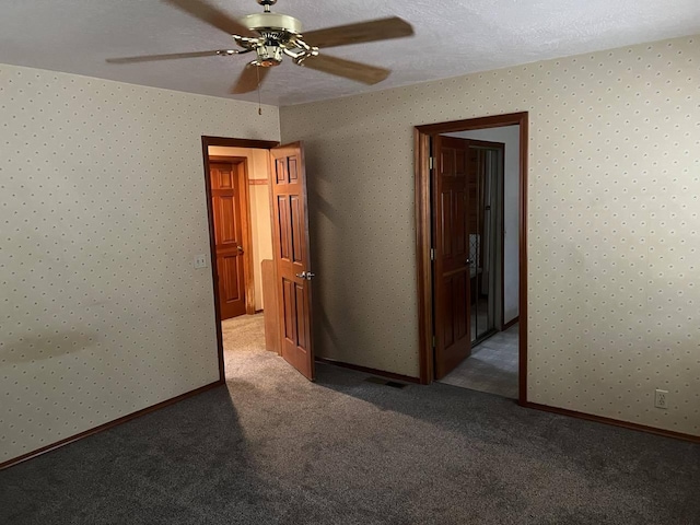 unfurnished bedroom with a textured ceiling, ceiling fan, and carpet floors