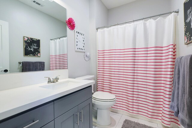 bathroom with tile patterned floors, vanity, and toilet