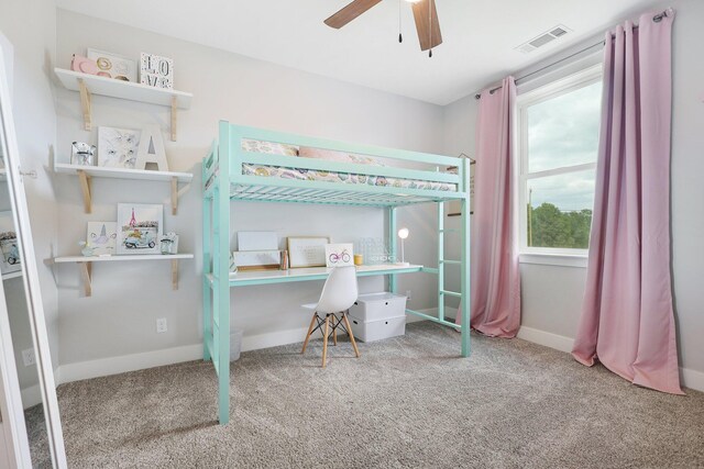 bedroom featuring carpet flooring, ceiling fan, and multiple windows