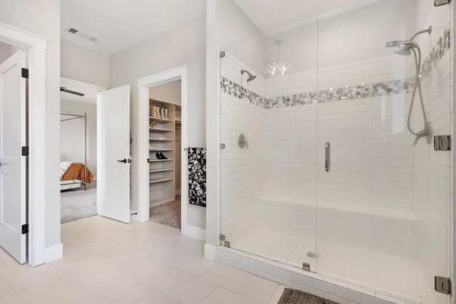 bathroom featuring a shower with shower door and tile patterned flooring