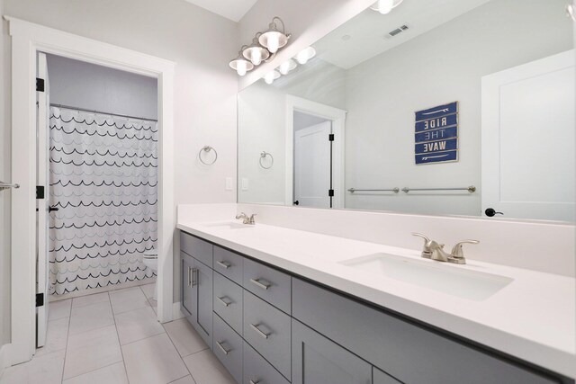 bathroom with tile patterned floors, vanity, and a shower with curtain