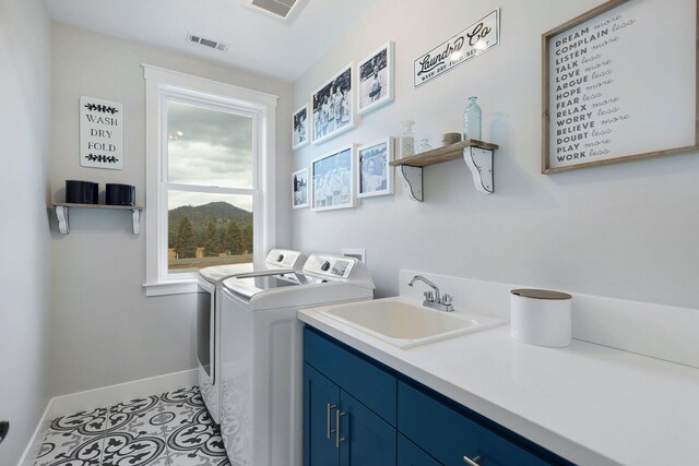 clothes washing area with sink, cabinets, separate washer and dryer, and light tile patterned floors