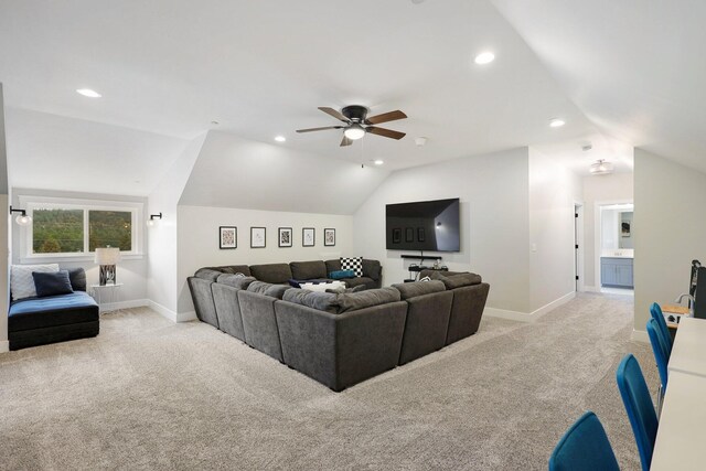 living room featuring ceiling fan, lofted ceiling, and light colored carpet