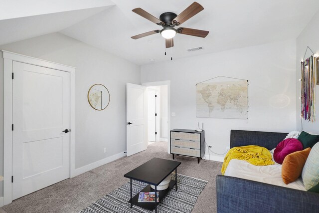 carpeted living room featuring ceiling fan