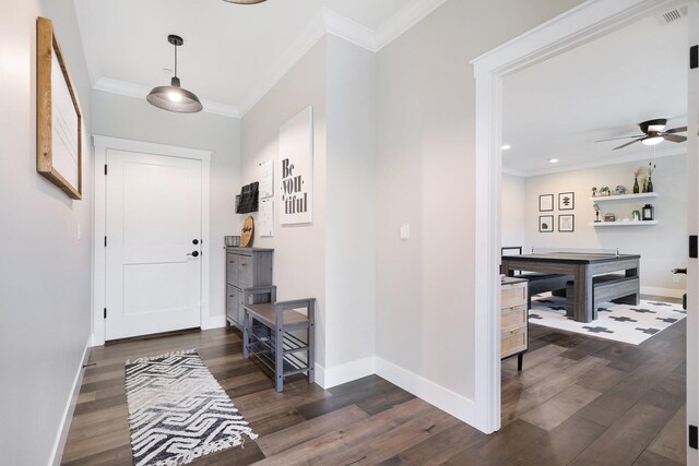 entrance foyer with ceiling fan, dark hardwood / wood-style flooring, and ornamental molding