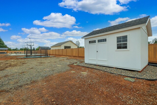 back of house featuring a shed