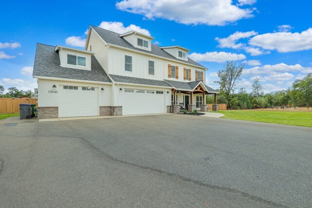 view of front of property featuring a garage and a front lawn