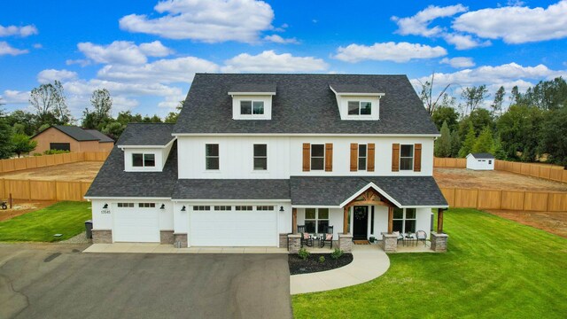 view of front of property featuring a garage and a front lawn