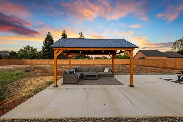 patio terrace at dusk featuring a gazebo and outdoor lounge area