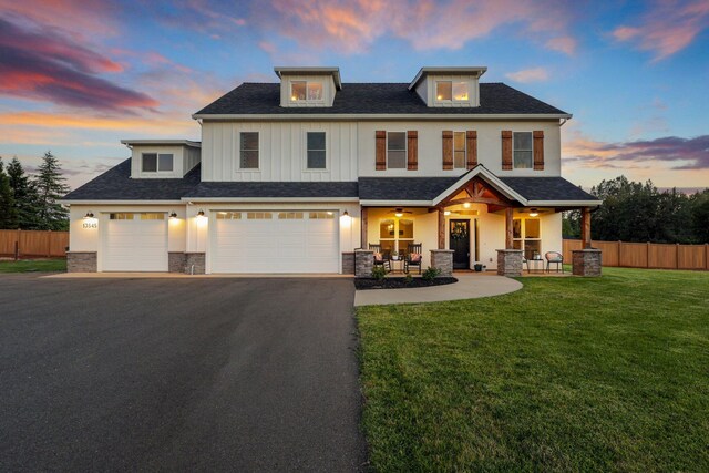 view of front of home with a garage and a yard