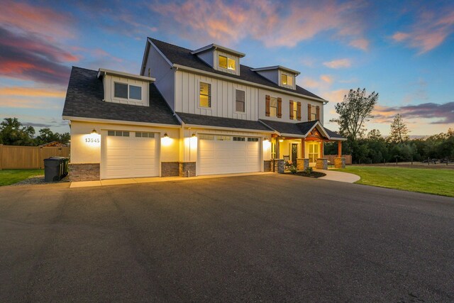 view of front of property featuring a garage and a yard