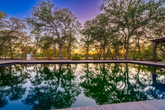 view of pool at dusk