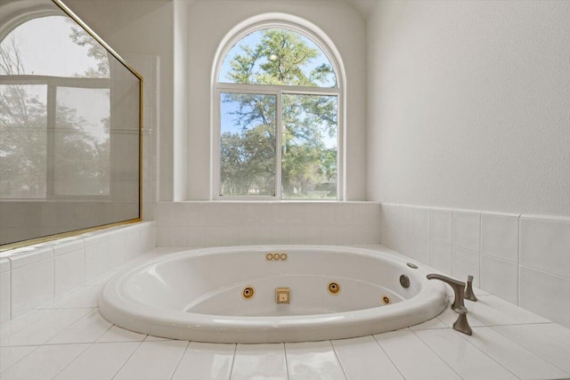 bathroom featuring a relaxing tiled tub