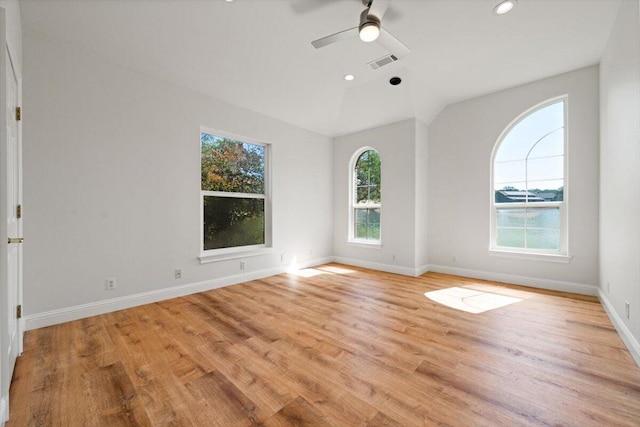 unfurnished room with ceiling fan, light hardwood / wood-style floors, and lofted ceiling