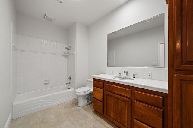 full bathroom with vanity, tile patterned floors, tiled shower / bath combo, and toilet