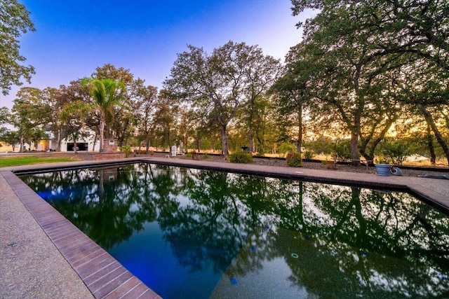 view of pool at dusk