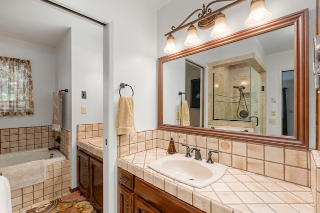 bathroom featuring vanity and shower with separate bathtub