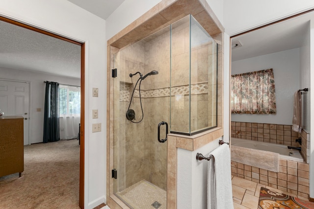 bathroom with tile patterned flooring, a textured ceiling, and shower with separate bathtub