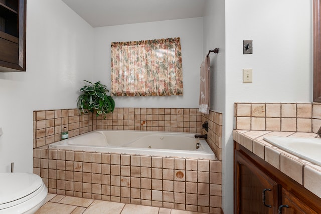 bathroom with tile patterned flooring, toilet, tiled tub, and vanity