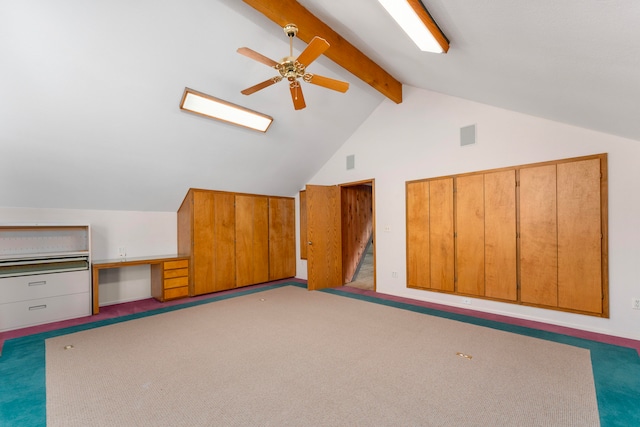 bonus room with ceiling fan, lofted ceiling with beams, and light carpet