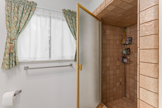 bathroom with a tile shower