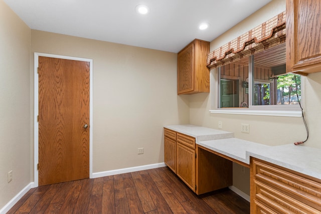 kitchen featuring dark hardwood / wood-style floors and built in desk