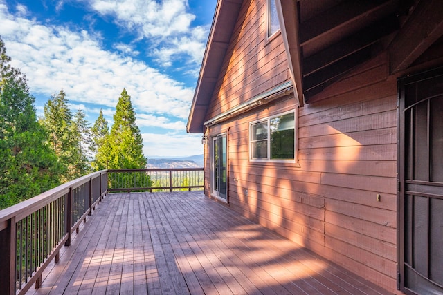 wooden deck with a mountain view