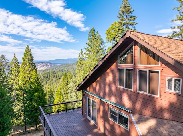 view of property exterior with a deck with mountain view