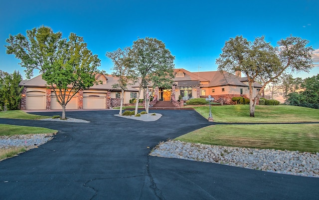 view of front of home with a front lawn and a garage