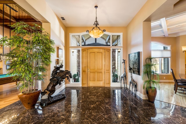 entryway featuring hardwood / wood-style flooring and a high ceiling