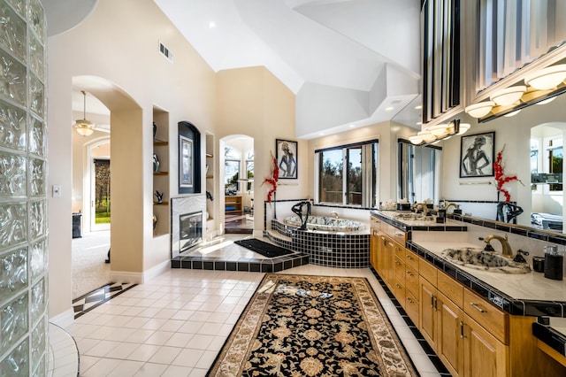 kitchen with light tile patterned floors, sink, and a high ceiling