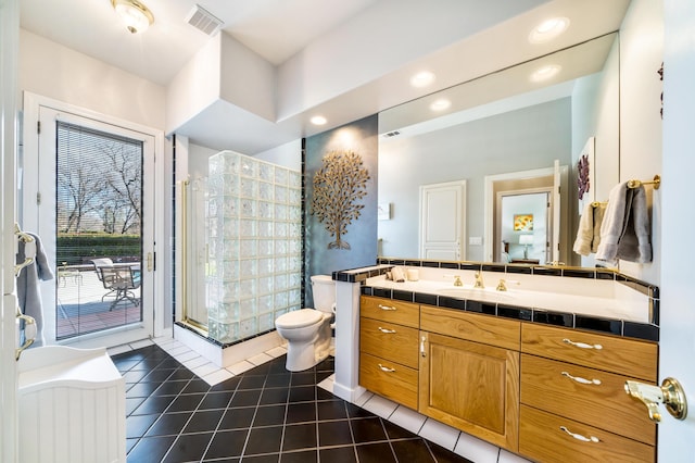 bathroom with a shower with shower door, toilet, tile patterned flooring, and vanity