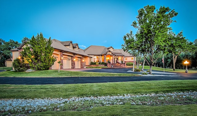 exterior space with a garage and a lawn