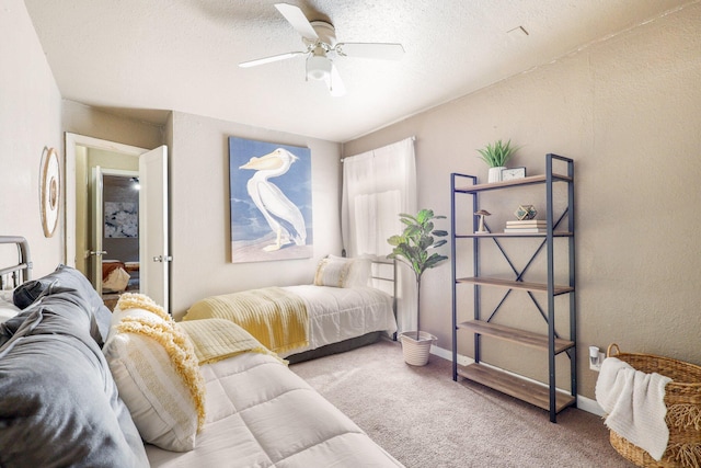 bedroom featuring a textured ceiling, ceiling fan, and carpet floors