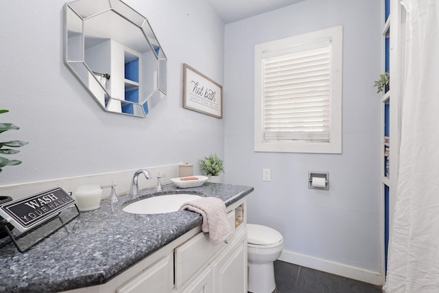 bathroom with tile patterned flooring, vanity, and toilet