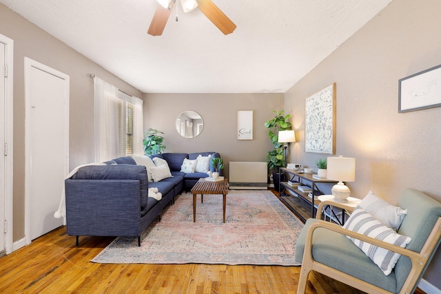 living room with hardwood / wood-style flooring and ceiling fan