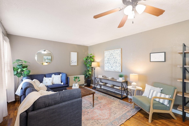 living room with ceiling fan and wood-type flooring