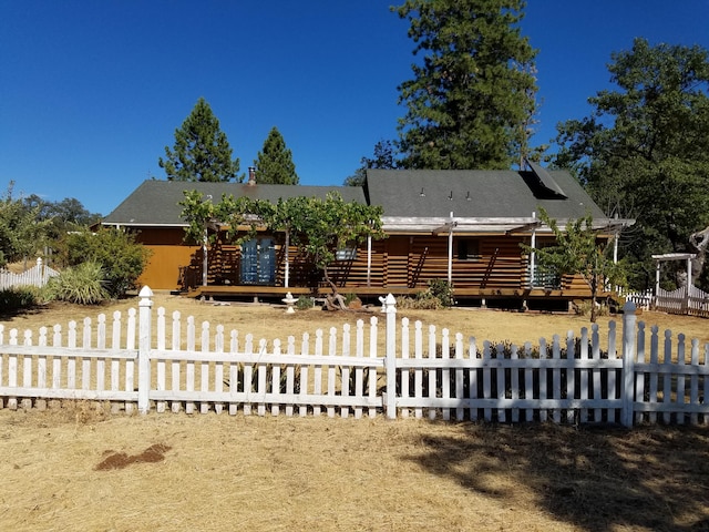 7414 Albers Forest Dr, Shingletown, CA 96088 - cabin featuring a fenced front yard, log siding, and a deck