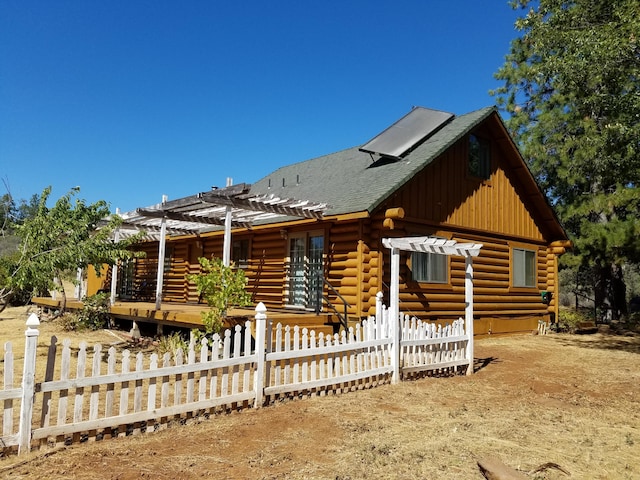 7414 Albers Forest Dr, Shingletown, CA 96088 - cabin with a pergola, a shingled roof, fence, and log exterior