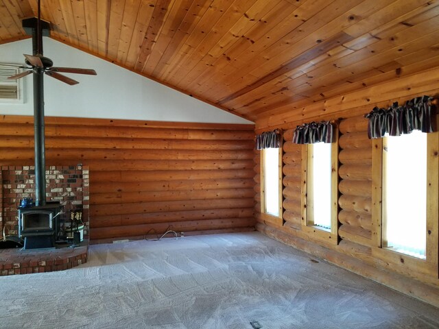 unfurnished living room with log walls, vaulted ceiling, a wood stove, and wood ceiling