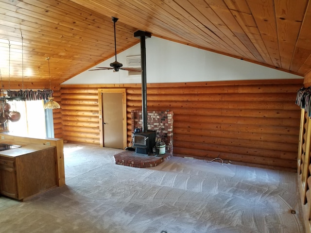 7414 Albers Forest Dr, Shingletown, CA 96088 - unfurnished living room featuring high vaulted ceiling, wood ceiling, a wood stove, log walls, and carpet
