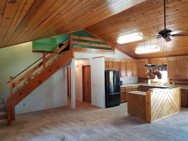 kitchen featuring ceiling fan, wood ceiling, light colored carpet, and black fridge