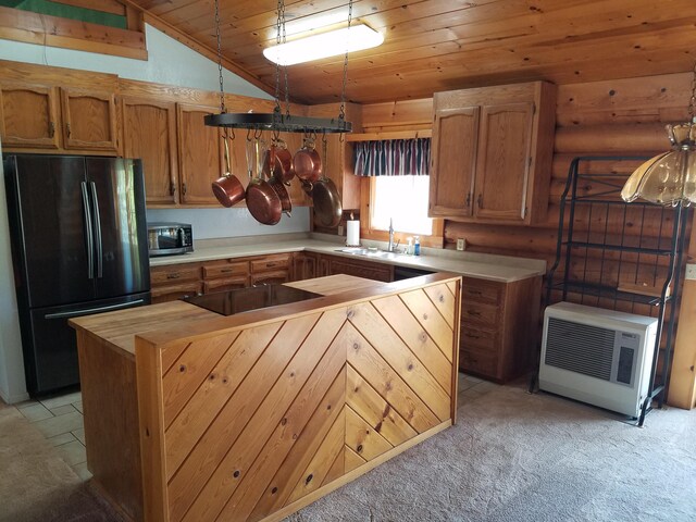 kitchen featuring sink, black appliances, lofted ceiling, and light colored carpet