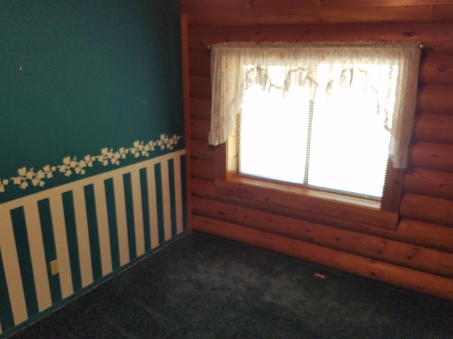 7414 Albers Forest Dr, Shingletown, CA 96088 - carpeted empty room with rustic walls