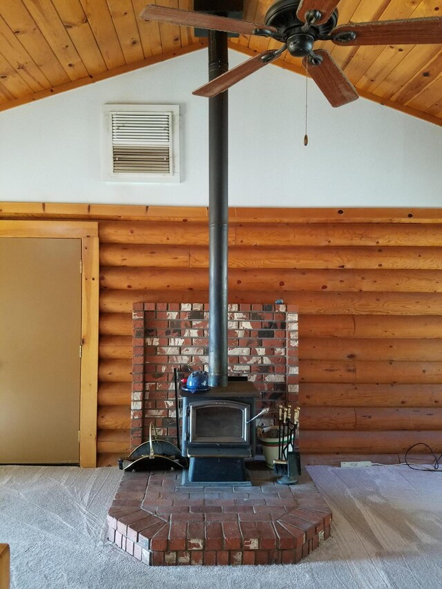 details with log walls, a wood stove, wooden ceiling, carpet floors, and ceiling fan