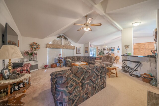 living room featuring ceiling fan with notable chandelier, light colored carpet, and vaulted ceiling