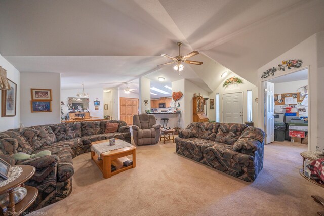 living room with lofted ceiling, ceiling fan, and carpet flooring